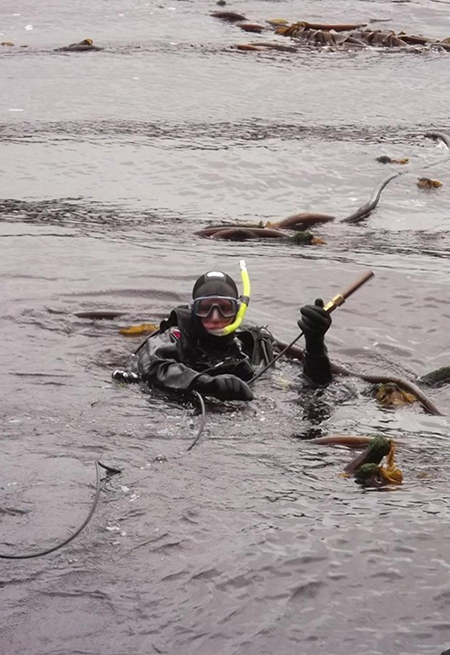 NOAA working diver placing orifice tubing for tide station in Alaska.