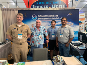 
	Members of Coast Survey standing in front of the NOAA booth