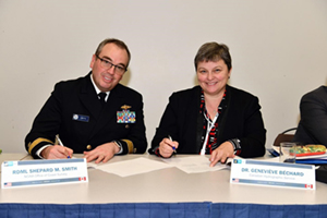 
	RDML Smith and Dr. Bechard signing agreement