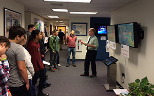 Dr. Kelley talks about bathymetry, weather, and ocean modeling with a group of middle school and high school students. and teachers.