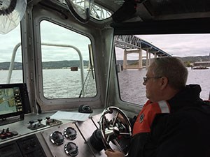 Darel McCormick (NOAA Small Boat Program)  behind the wheel during speed trials