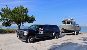 Navigation response team vehicle and response vessel in tow.