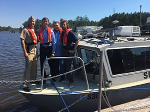 Lt. j.g. Collin Walker, Rear Adm. Tim Gallaudet (USN, Ret.), Josh Bergeron and Alex Ligon on the bow of the team's response vessel.