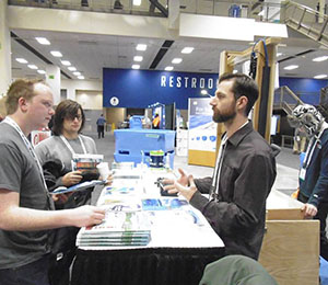 Adam Argento engages visitors to the NOAA booth at the Pacific Marine Expo