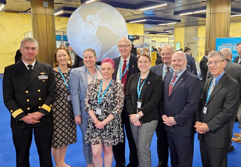 A group image of the NOAA delegation at the third IHO Assembly. From left to right, RDML Ben Evans, Jennifer Jencks, Julia Powell, Megan Bartlett, Andy Armstrong, Alexis Maxwell, Jonathan Justi, John Nyberg, and Peter Oppenehimer.