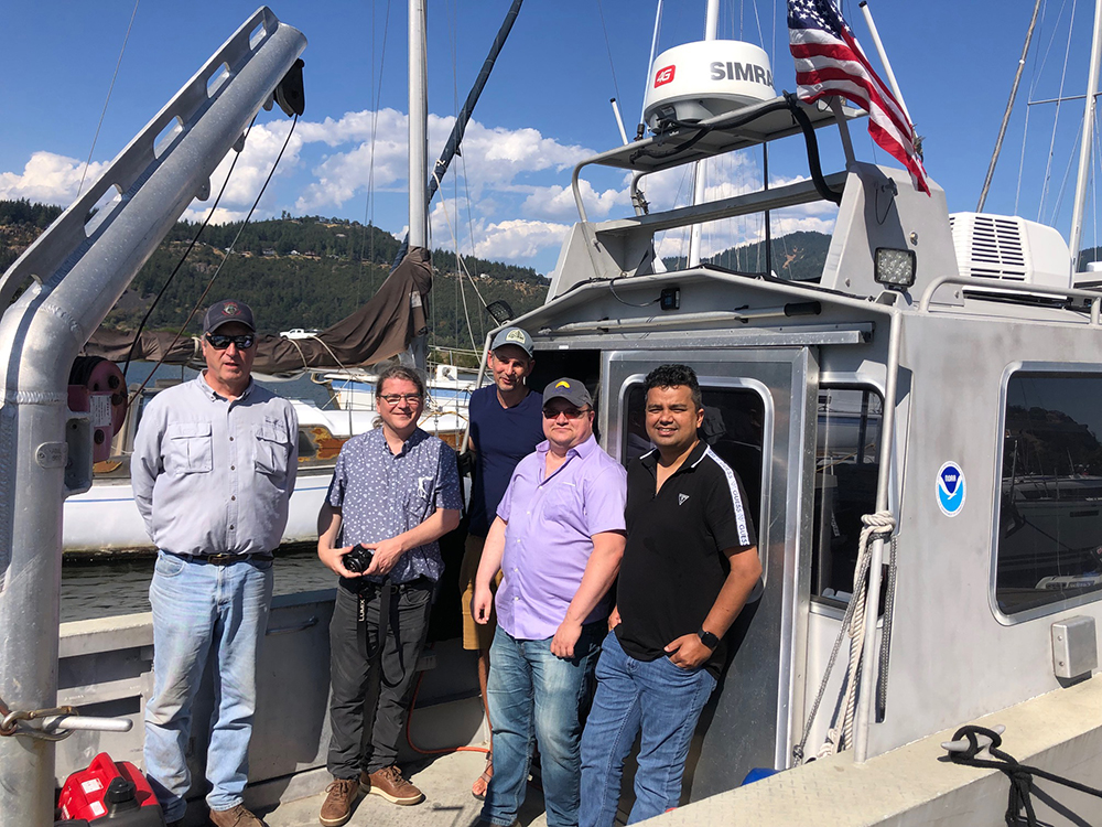 From left to right, an image showing Bill Sharp from Yakama Nation Fisheries, Charles Seaton, David Graves, Mike Swirsky, and Sanjeev Joshi, of CRITFC aboard the navigation response vessel.