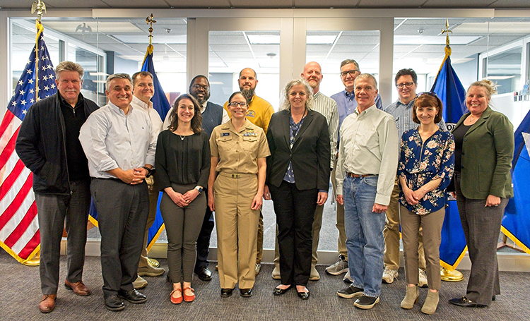 A group image of participants in the navigation managers meeting held in March 2023. From left to right: Tim Osborn, Nicolas Alvarado, Kyle Ward, Colleen Roche, Quentin Stubbs, LCDR Hadley Owen, Ryan Wartick, Lucy Hick, Darren Wright, Jeffrey Ferguson, Tom Loeper, Steve Soherr, Kathy Carpenter, and Julia Powell.
