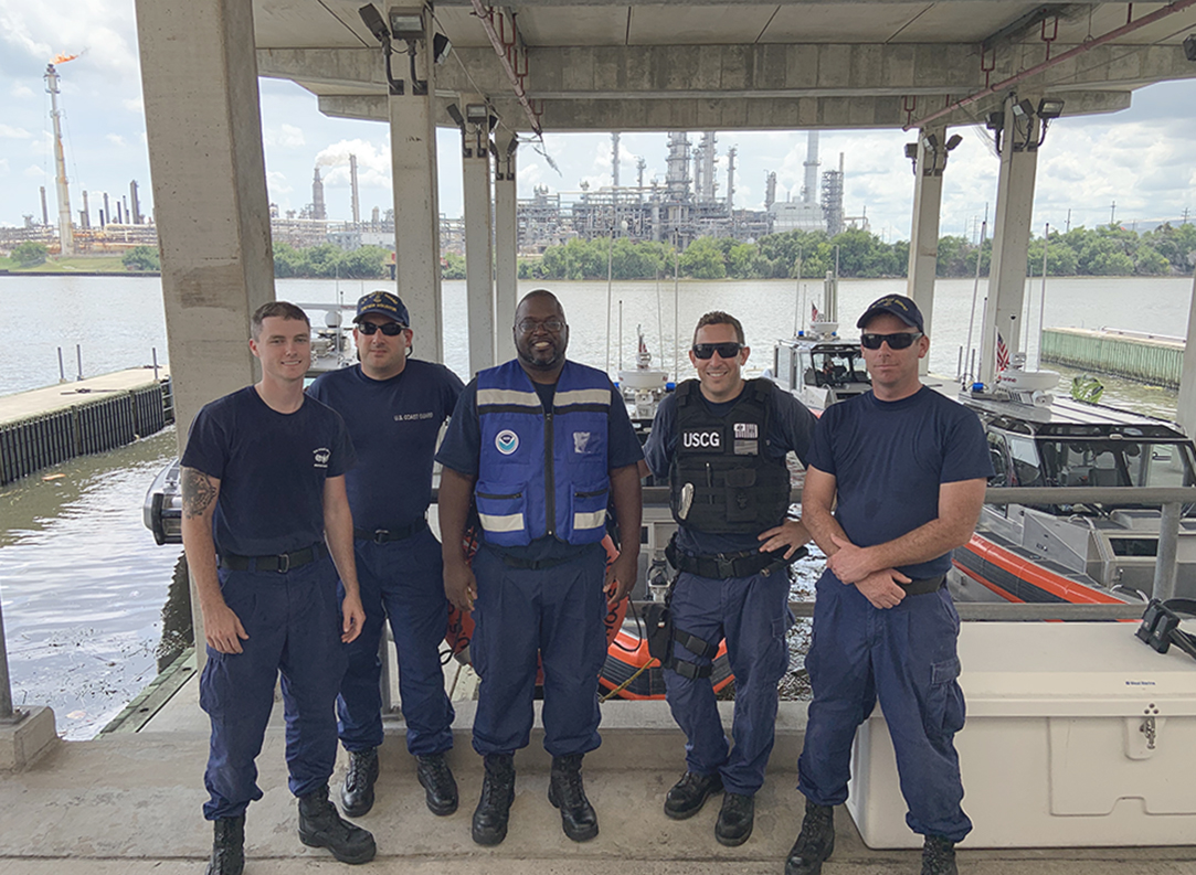 An image of Texas Navigation Manager Quentin Stubbs (center) with the U.S. Coast Guard crew.