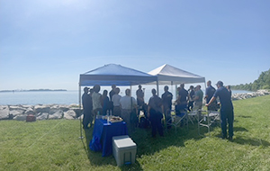 An image showing attendees of the unrewed systems open house under a tent at Possum Point near Annapolis, Maryland.