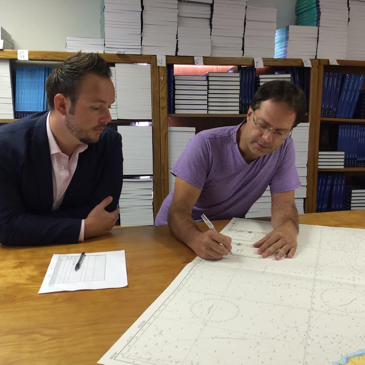 Guy Funnell (left) meets with NOAA-certified print-on-demand chart sub-agent Horizon Nautical.