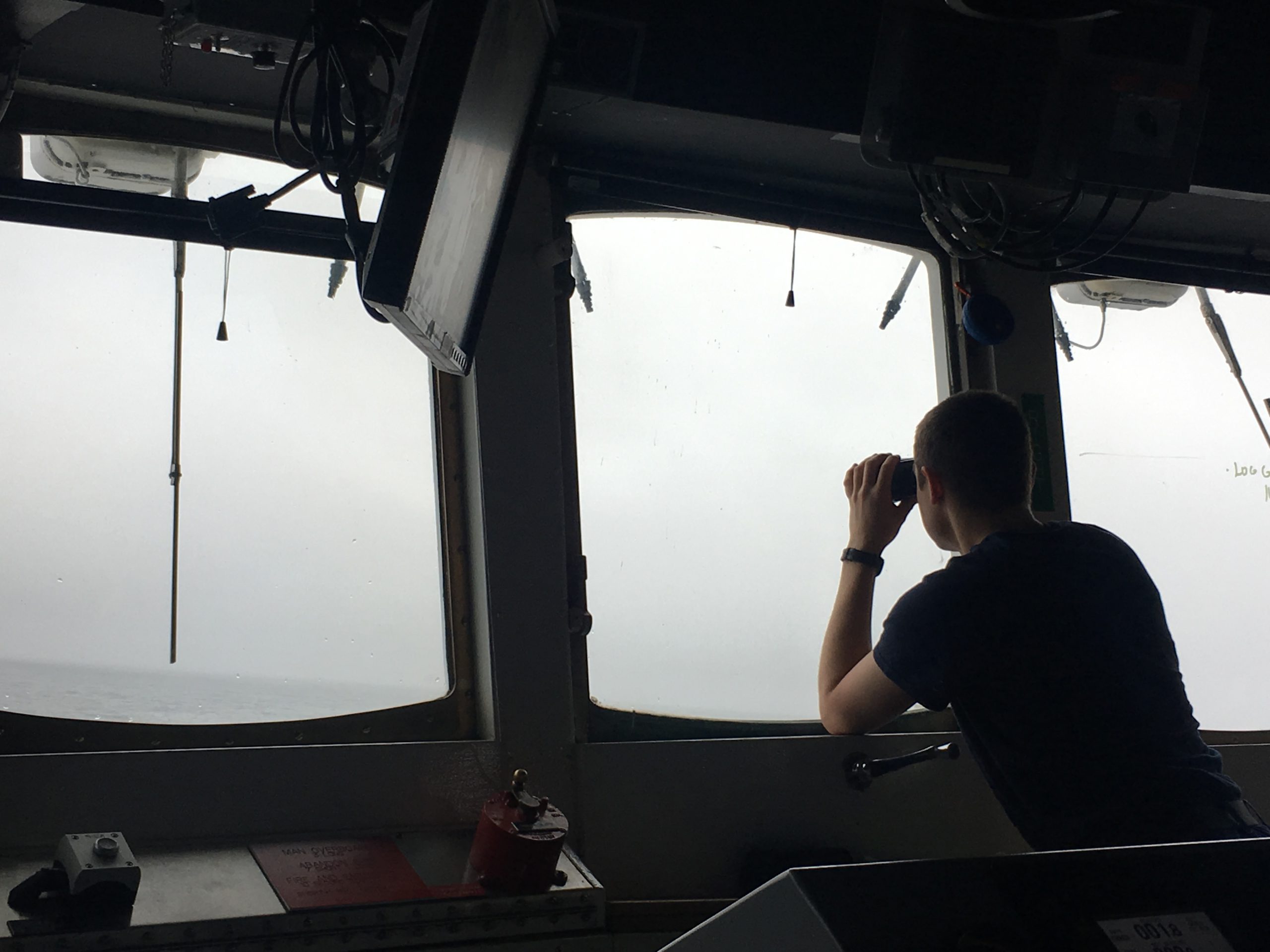 A NOAA Corp officer watches for hazards to navigation on board NOAA Ship Fairweather.