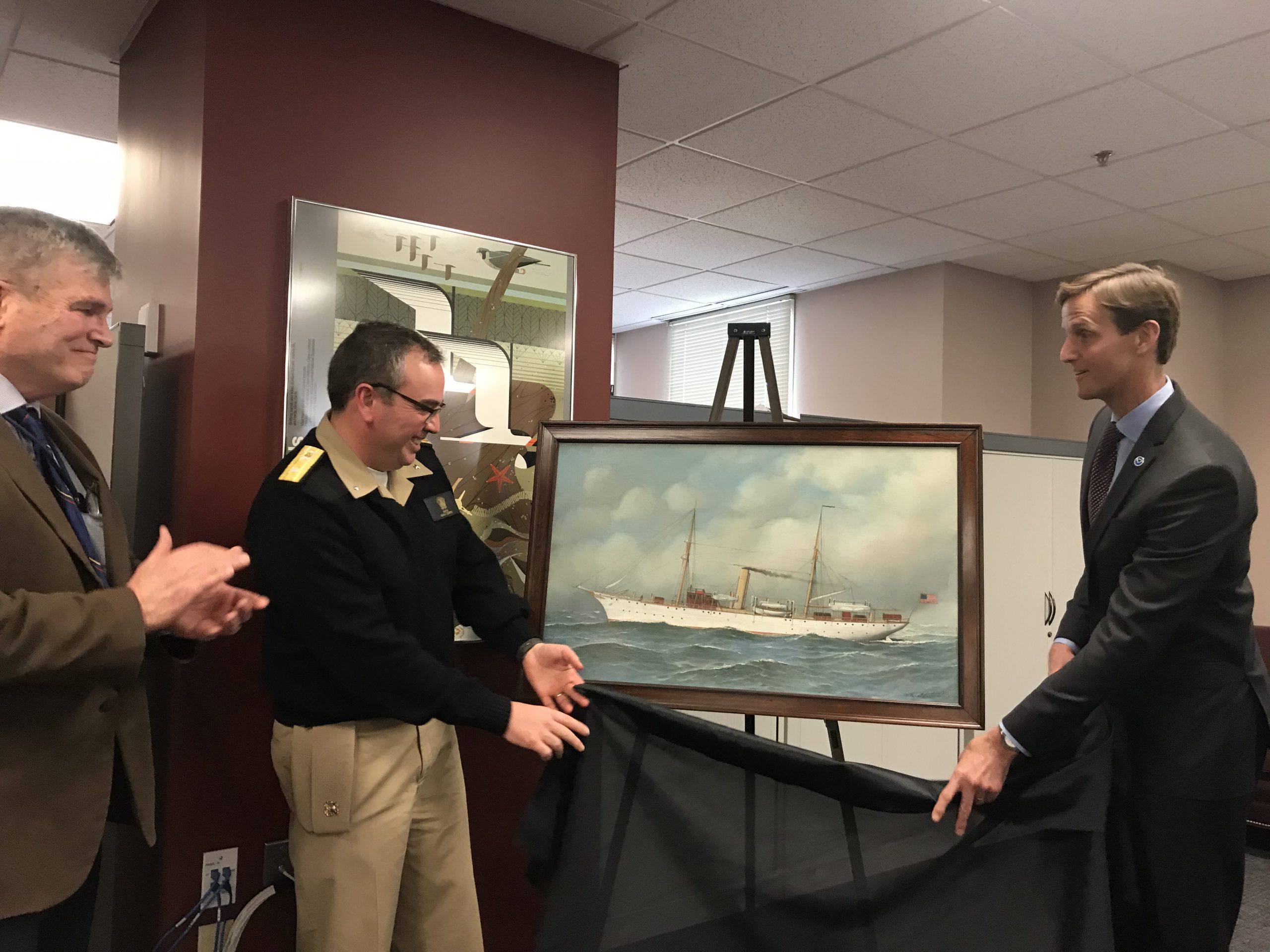 Capt. Skip Theberge, NOAA ret., Rear Adm. Shepard Smith, NOAA, and ear Adm. Tim Gallaudet, USN ret., unveil the Pathfinder painting.