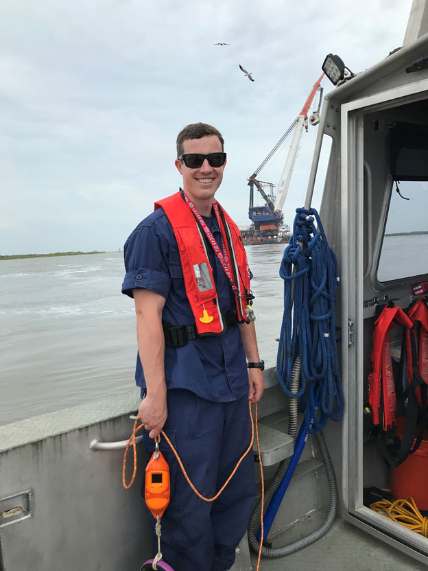 Lt. j.g. Patrick Lawler waits to take a cast off of survey vessel.