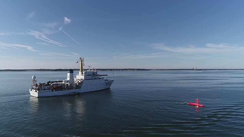 An image showing NOAA Ship Thomas Jefferson testing an unmanned surface vehicle. 