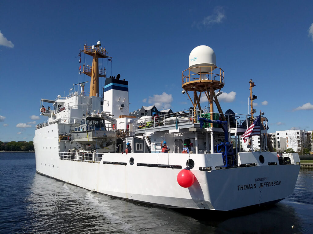 An image showing the stern of NOAA Ship Thomas Jefferson as it's getting underway and leaving her home port in Norfolk, Virginia.