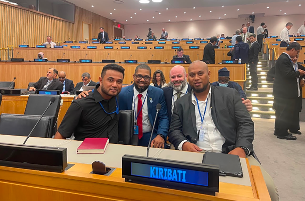 An image showing from left to right: Robert (Kiribati), Diego (Jamaica), John (USA) and Tion (Kiribati) at the Eleventh Session of the United Nations Committee of Experts on Global Geospatial Information Management, in New York, August 2022.