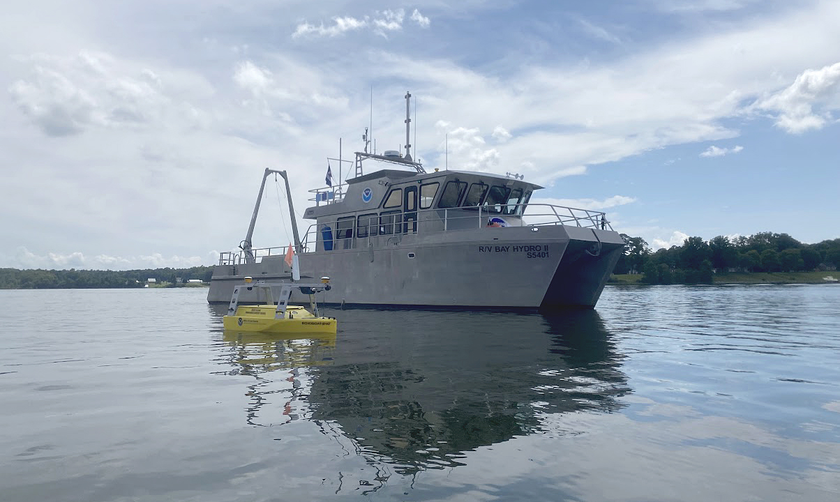 An image of NOAA's Bay Hydro II on the water with the Echoboat 240, uncrewed system in the foreground.