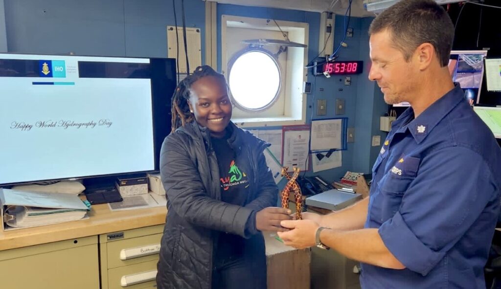 Presenting a souvenir to the commanding officer of NOAA Ship Thomas Jefferson after country presentation on World Hydrography Day.