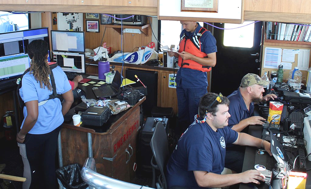 An image showing both teams hard at work aboard Bay Hydro II.w