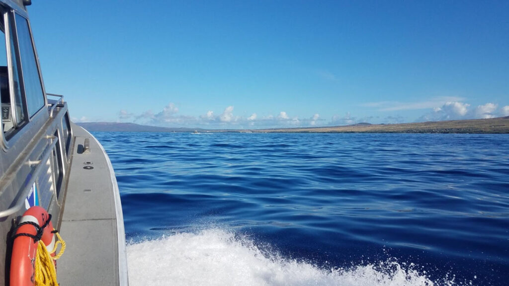 A Rainier hydrographic survey launch transits between the islands of Maui and Moloka'i.