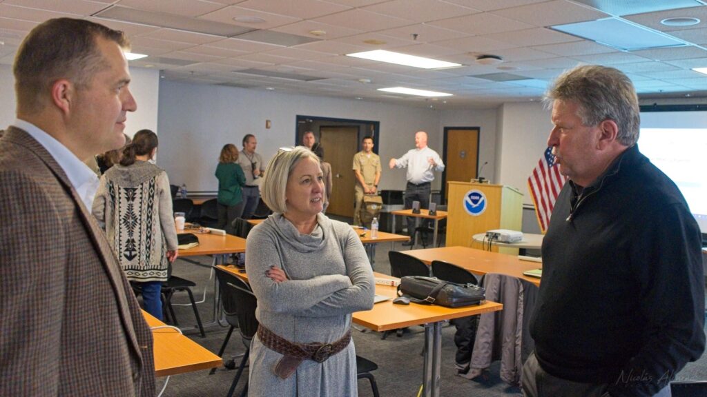 Rachael Dempsey, Deputy Assistant Administrator for Navigation, Observations, and Positioning, talks with Tim Osborn, Navigation Manager